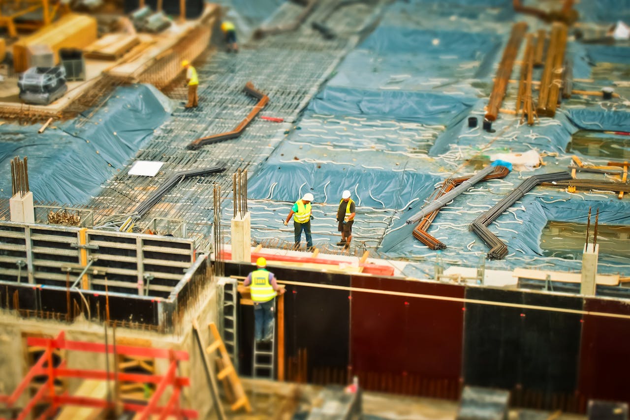 creative-01 High-angle view of construction workers on a building site, engaging in construction work.