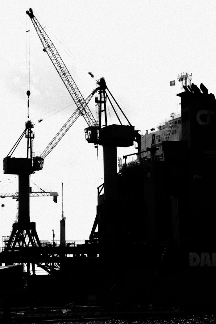 brand-02 Black and white silhouette of cranes at a port in Dunkerque, France.