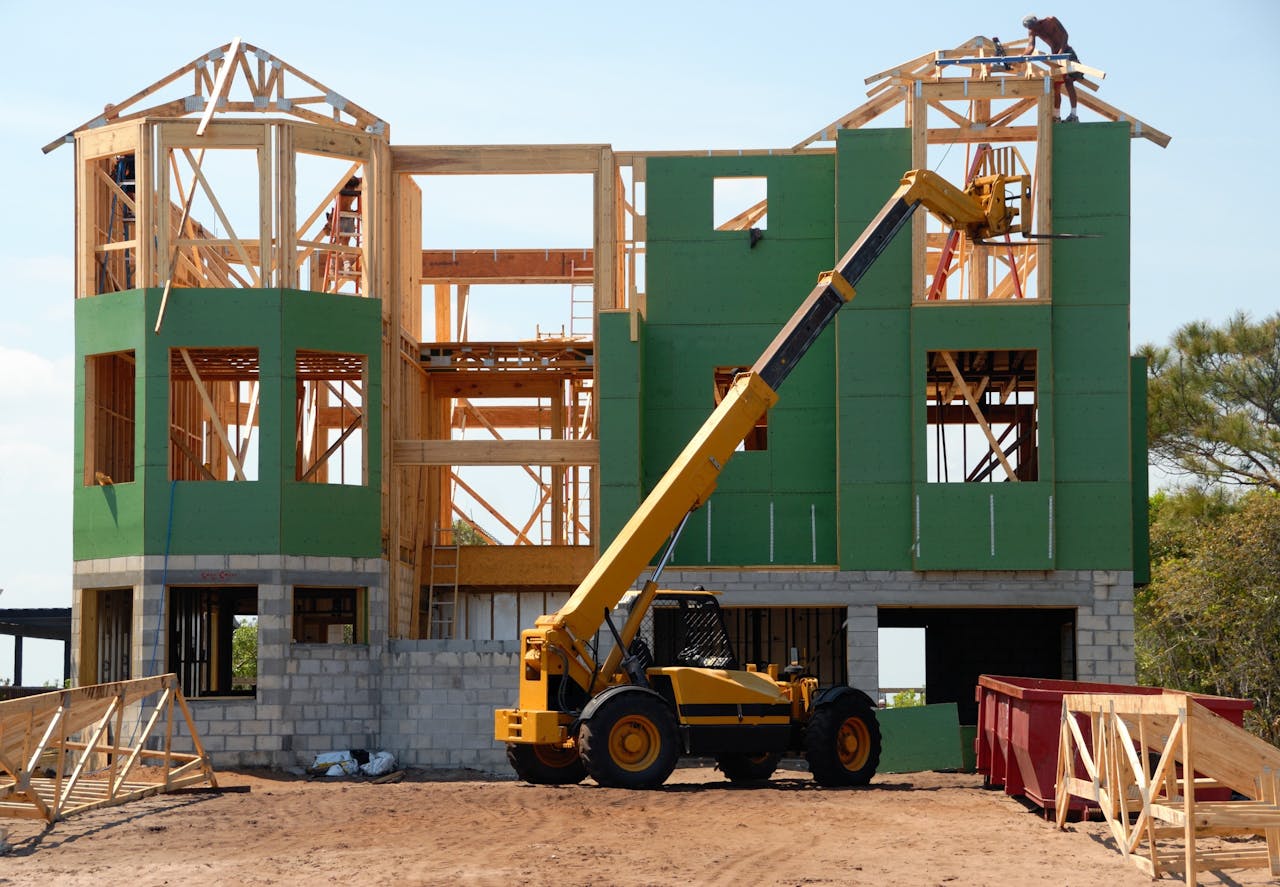 creative-02 A multi-story wooden house under construction using a crane on a sunny day.